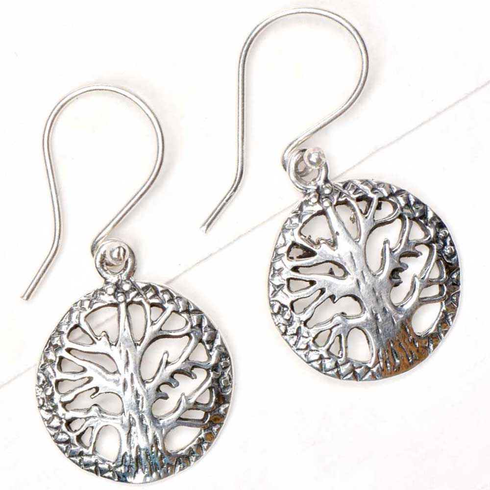 Side view showing cross stitch, round, tree design on Reet earrings