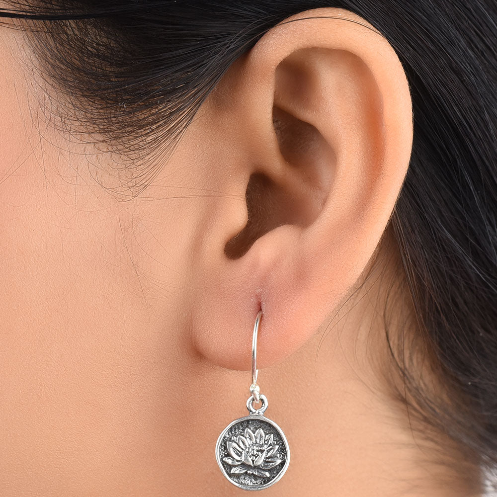 Pair of 92.5 sterling silver oxidized sun flower earrings displayed elegantly