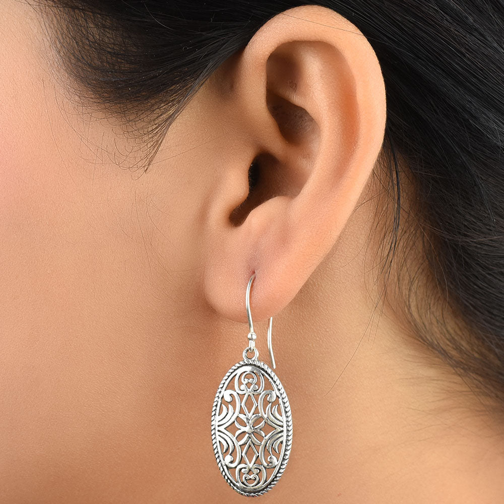 Pair of 92.5 sterling silver floral earrings displayed elegantly