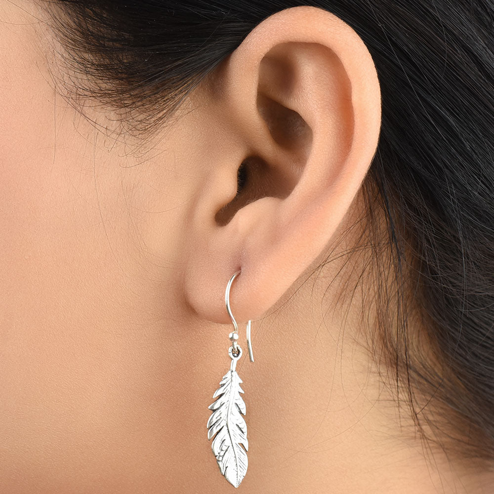 Pair of 92.5 sterling silver leaf earrings displayed elegantly