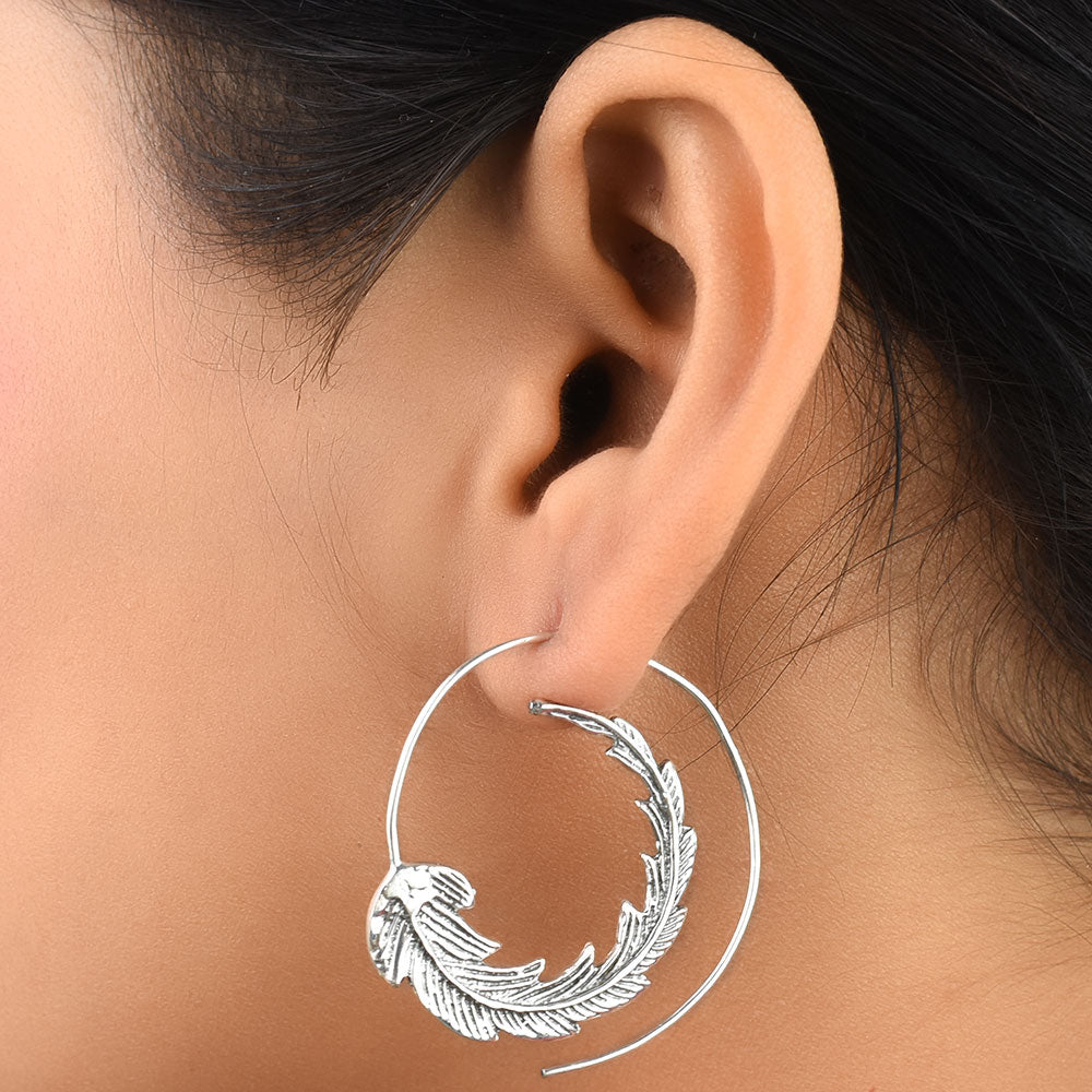 Pair of 92.5 sterling silver leaf hoop earrings displayed elegantly