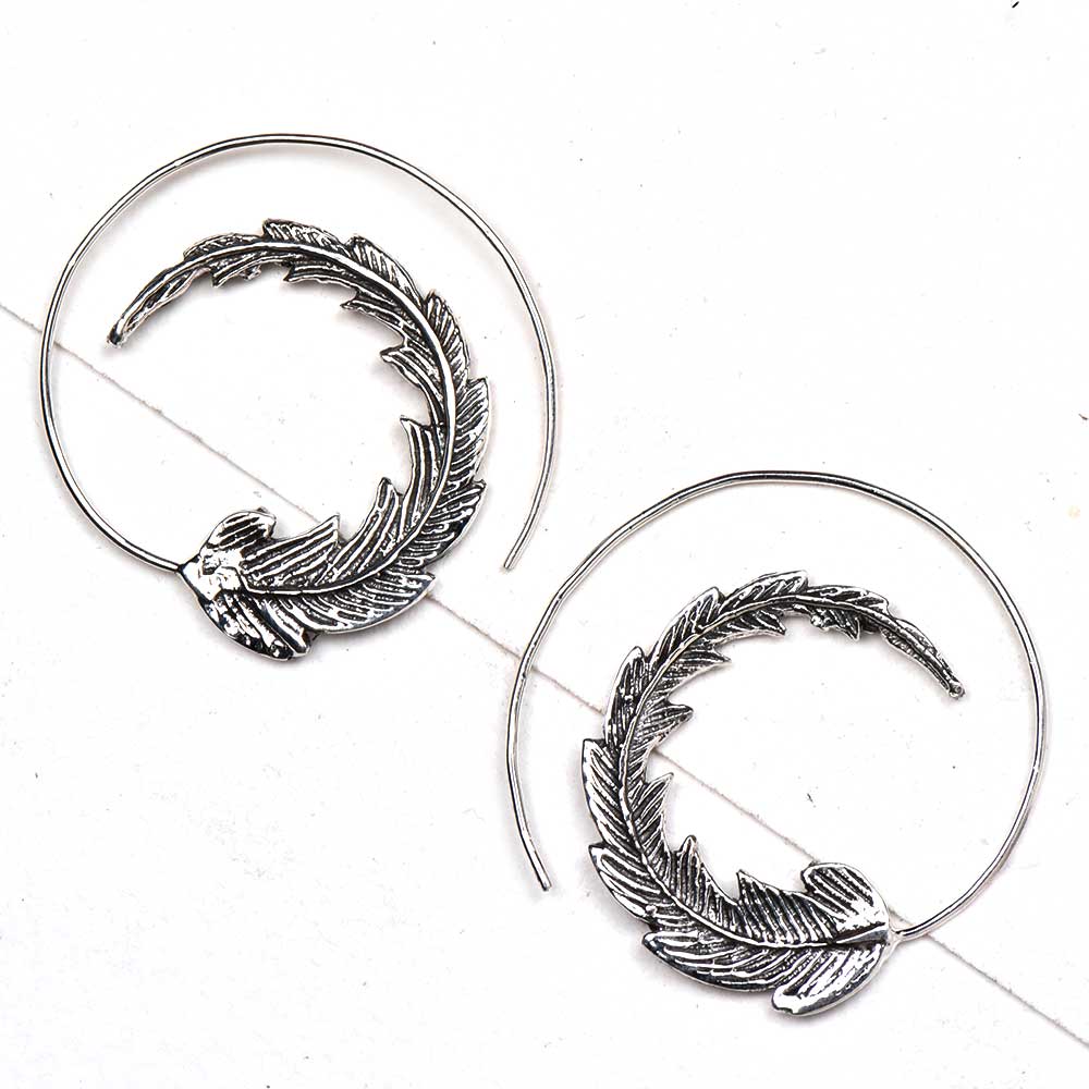 Detailed shot highlighting the craftsmanship of 92.5 sterling silver leaf hoop earrings