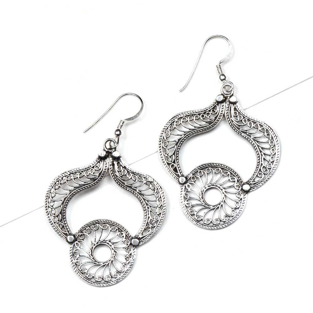 Angle view of Reet dangle earrings capturing the shine of 92.5 Sterling Silver
