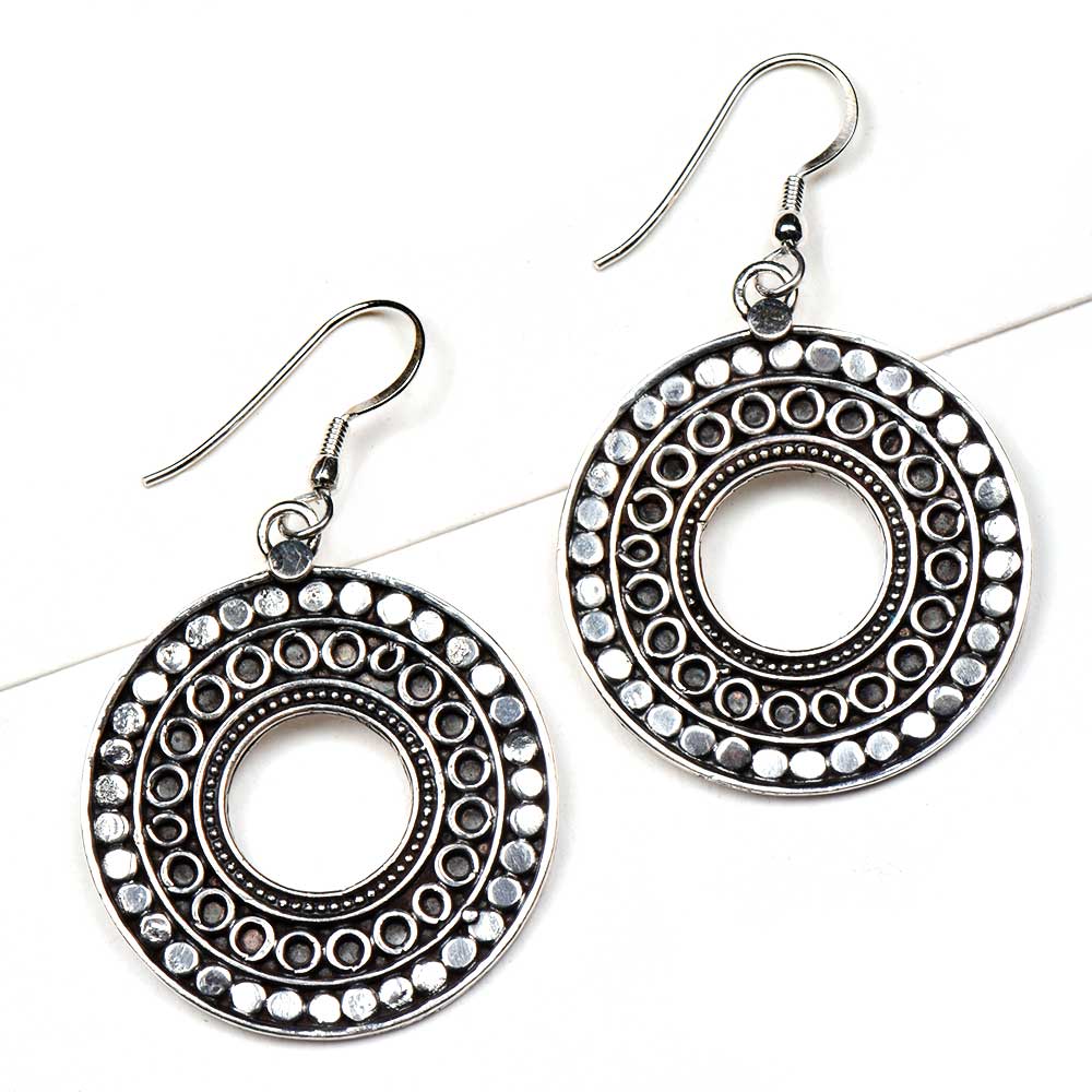 Handmade disc and engraved earrings showcasing traditional craft