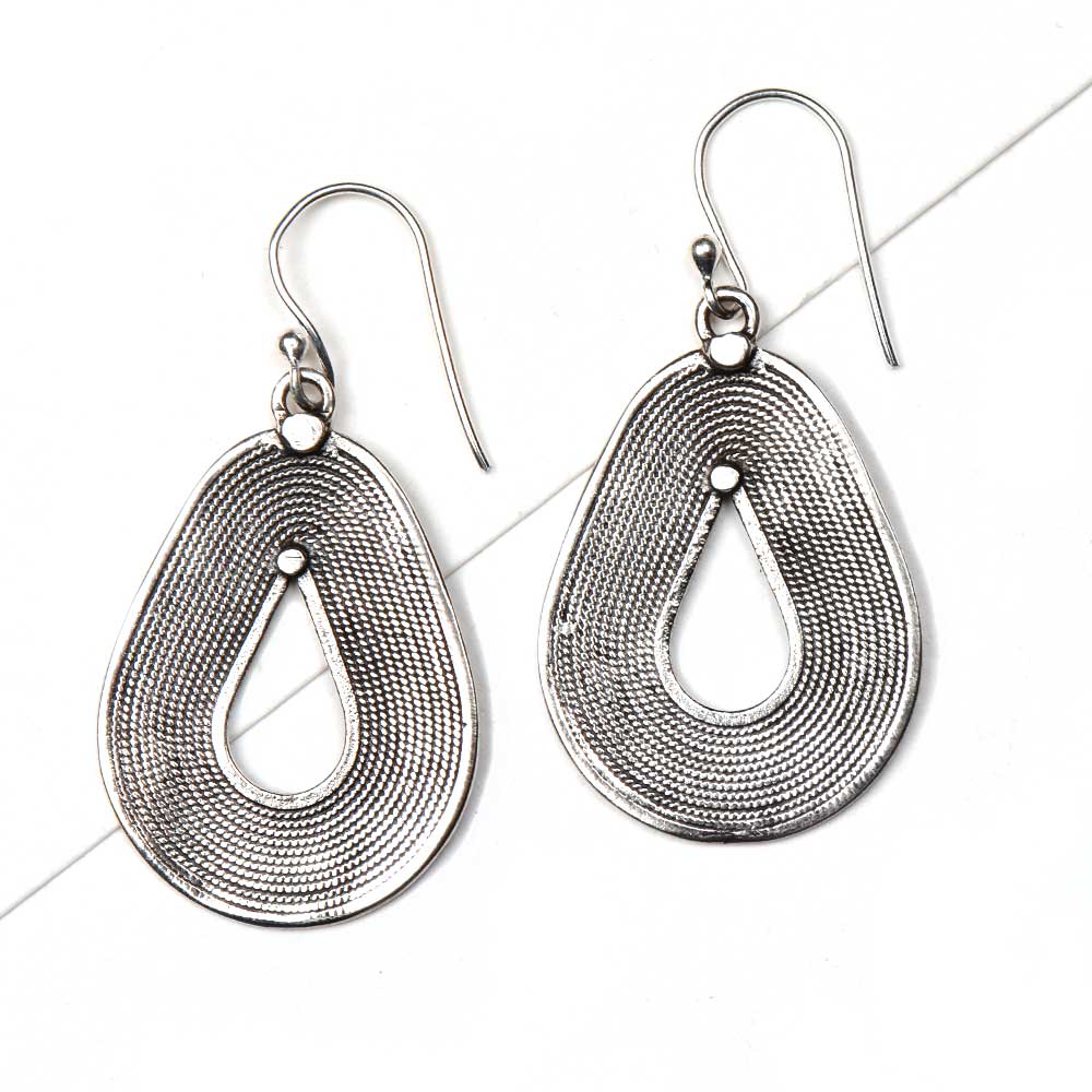 Angle view of Reet dangle earrings capturing the shine of 92.5 Sterling Silver