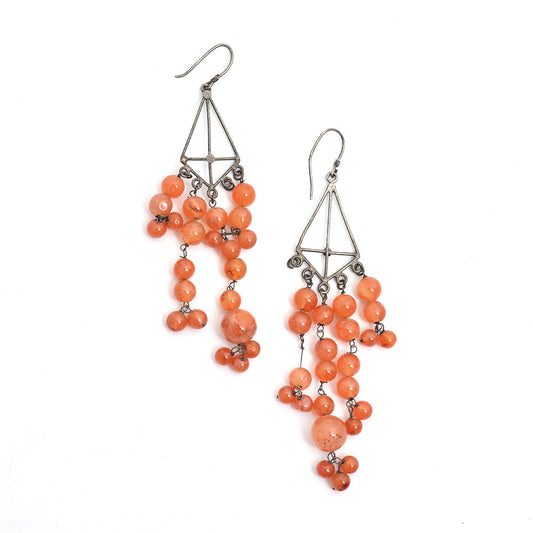 Artistic composition of carnelian dangle earrings with Silver & Orange embellishments and 92.5 Sterling Silver.