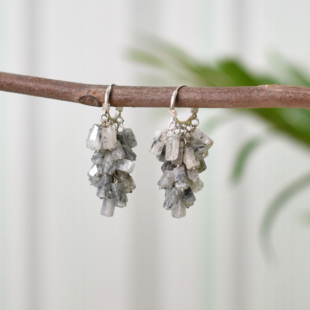 Model wearing Labradorite dangle earrings in 92.5 Sterling Silver with a minimalist outfit.