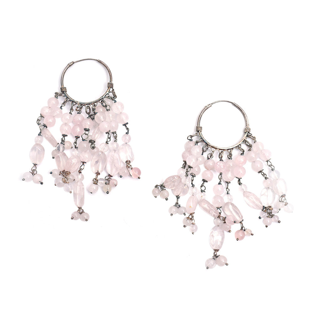 Lifestyle shot showing the size and drop of the pink hook hanging earrings made from 92.5 Sterling Silver.