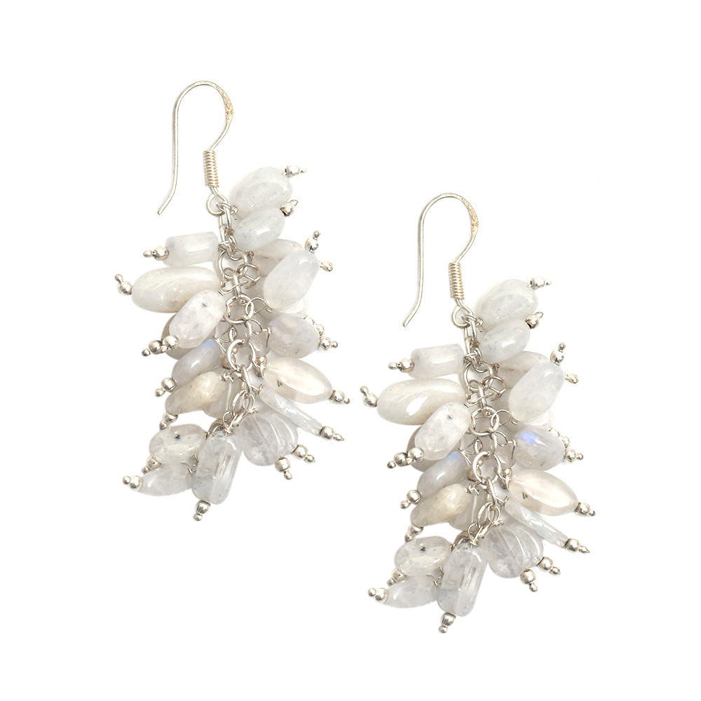 Lifestyle shot showing the size and drop of the moonstone moon dangle earrings made from 92.5 Sterling Silver.