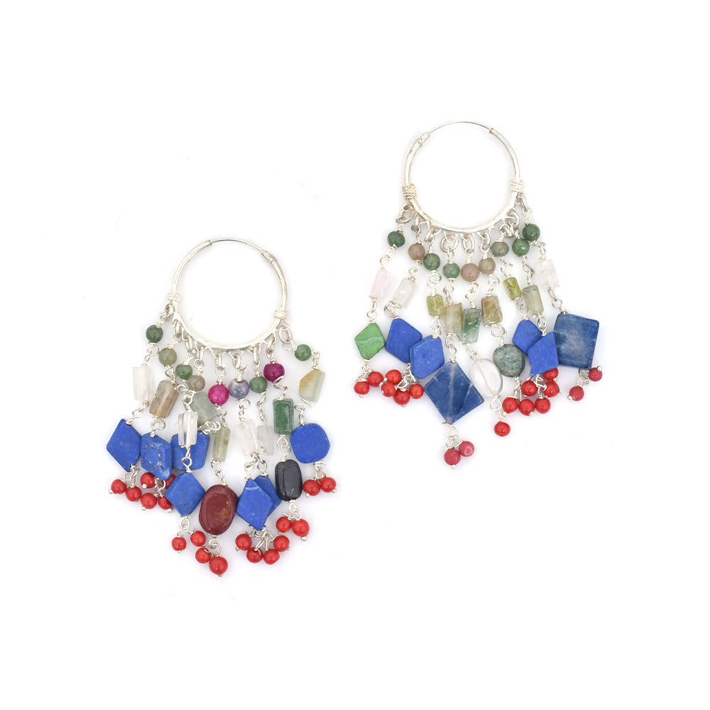 Pair of lapis dangle earrings laid flat, displaying handcrafted craftsmanship in 92.5 Sterling Silver.