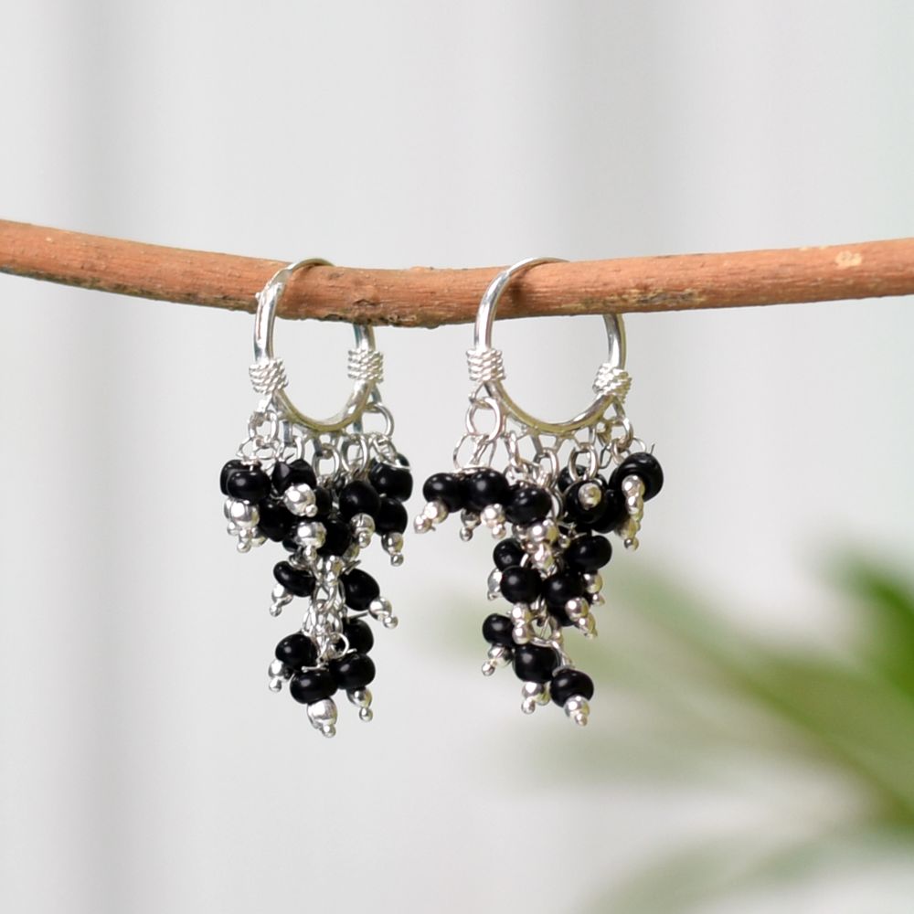 Pair of Black Onyx Hoop Earrings on a display stand, crafted from 92.5 Sterling Silver.